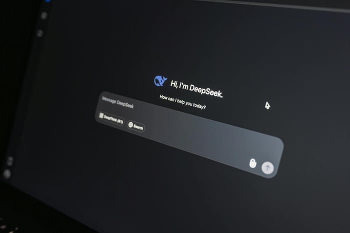Close-up of DeepSeek AI chat interface on a laptop screen in low light.