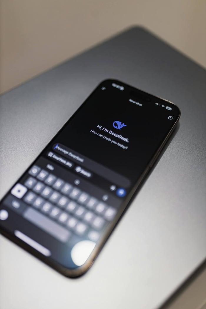 Smartphone with DeepSeek AI interface on a laptop keyboard, showcasing technology and innovation.